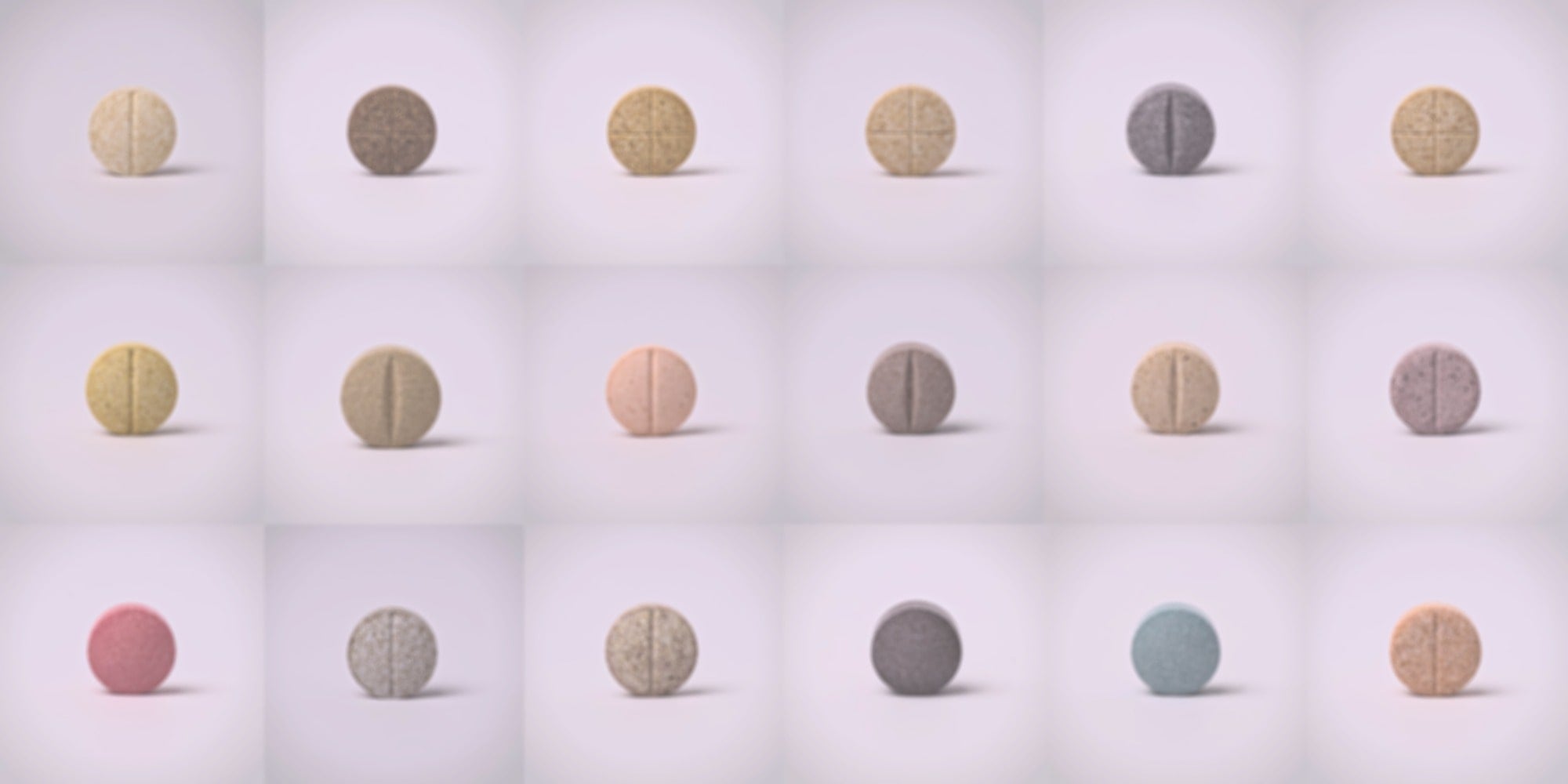 Grid of round, multicolored 7-oh tablets on a light gray background
