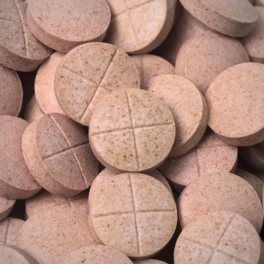Close-up of beige 7ohBLACK 7-oh tablets with cross-section visible