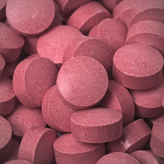 Close-up of red 7ohBLACK 7-oh tablets stacked together