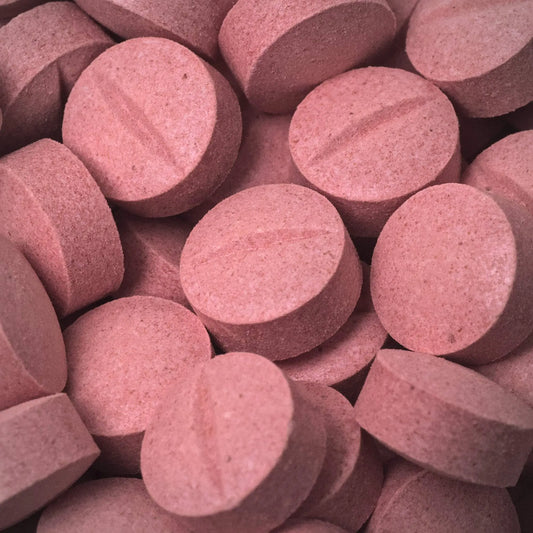 Close-up of pink 7ohBLACK 7-oh tablets